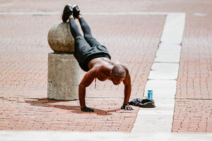 Street workout where man is doing push ups