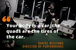 Group workout session with the Your body is your car, the quads are the tires of the car quote over it