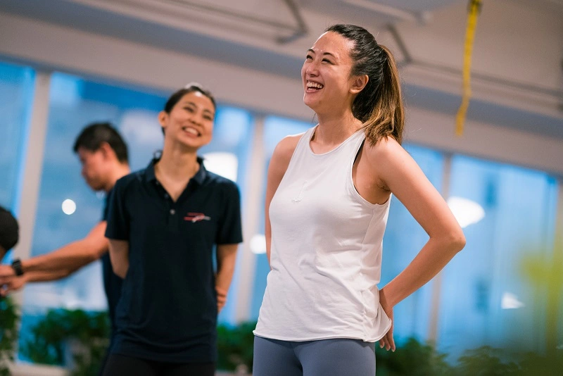 Trainer and a girl smilling during small group training session
