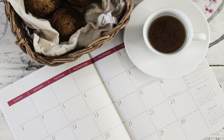 Calendar with tea and cookies on the side